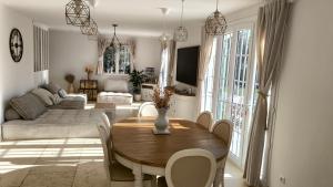 a living room with a table and a couch at Lou Masadous : Magnifique villa tout confort avec piscine chauffée 11x3.5 in Montauroux