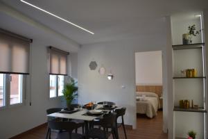 a dining room with a table and chairs at Apartamento La Colmena in Ayora +20 photos