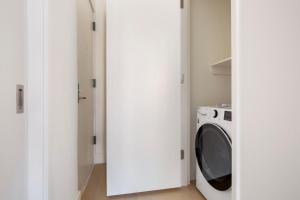 a white laundry room with a washer and dryer at Blueground Chelsea elev wd nr 8th Ave NYC-1451 in New York