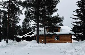 a log cabin with snow on the roof at Sälen Moderna Lodge in Sälen
