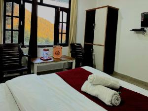 Cama o camas de una habitación en Guest House Mcleodganj Dharamshala
