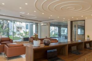 a living room with a desk with a laptop on it at The Tanisi Hotels and Resorts, Candolim in Candolim