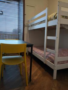 a desk and a chair in a room with bunk beds at Appartamento Cenisia Fermata Racconigi in Turin