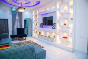 a living room with a blue couch and a fireplace at House 13 Apex in Lagos