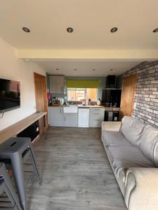a living room with a couch and a kitchen at B3 Rickardos Holiday Lets in Mablethorpe