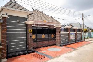 a house with a gate on the side of it at House 13 Apex in Lagos