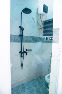 a shower in a bathroom with a toilet at House 13 Apex in Lagos