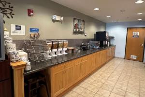 a restaurant with a counter with a counter at Microtel Inn & Suites Tomah in Tomah