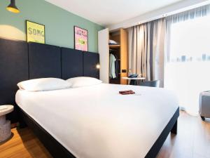 a bedroom with a large white bed in a room at ibis Paris Bastille Faubourg St Antoine in Paris