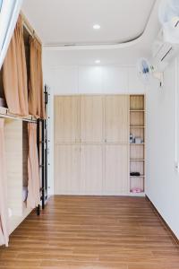 a room with white cabinets and a hard wood floor at Lullaby homestay in Hue