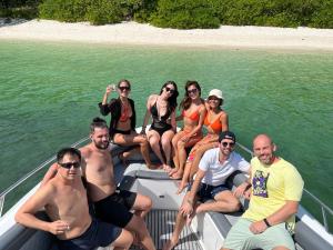a group of people sitting on the back of a boat at Alunan Resort in Perhentian Island