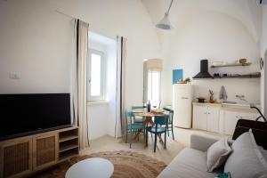 una sala de estar con un sofá y una mesa en Skafè Apartments, en Uggiano la Chiesa