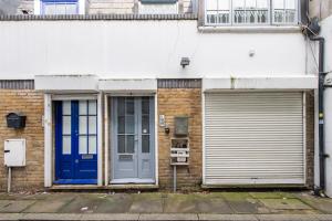 a building with two doors and a garage at Charming 1Bed in Kings Cross in London