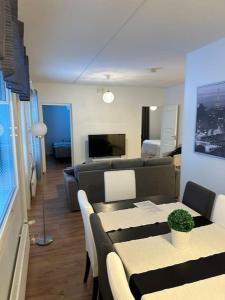 a living room with a couch and a table at ”Paris” -2BR with sauna&balcony in Tornio