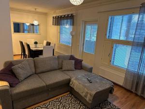 a living room with a couch and a table at ”Paris” -2BR with sauna&balcony in Tornio