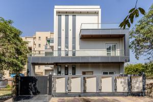 a house with a fence in front of it at Lime Tree B&B Pari Chowk in Greater Noida
