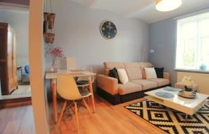 a living room with a couch and a table at Apartamenty NOVA na Krakowskiej No 2 in Bielsko-Biala +15 photos