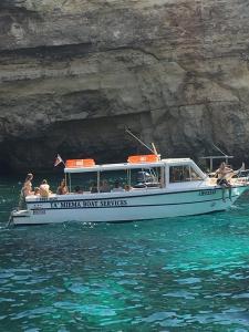 a group of people on a boat in the water at Comino Gozo Private Boat Trips Charters in Għajnsielem