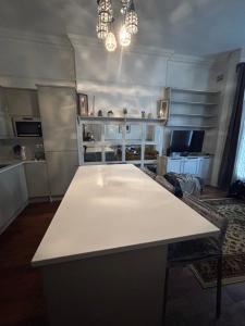 a kitchen with a white table in a room at Modern Apartment in Holland Park in London