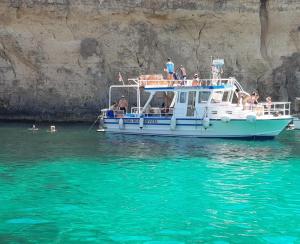 a group of people on a boat in the water at Comino Gozo Private Boat Trips Charters in Għajnsielem