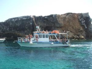 a group of people on a boat in the water at Comino Gozo Private Boat Trips Charters in Għajnsielem