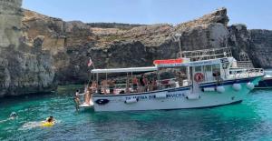 a boat in the water with people on it at Comino Gozo Private Boat Trips Charters in Għajnsielem