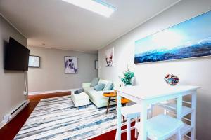 a living room with a couch and a table at Redwood loft at Park Place King bed walk in closet fast WIFI and free coffee in Wilmington