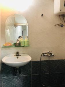 a bathroom with a sink and a mirror at Head of Quarter -TRIPLE BED ROOM- CHEAP in Hanoi