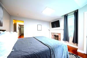 a bedroom with a large bed and a fireplace at Redwood loft at Park Place King bed walk in closet fast WIFI and free coffee in Wilmington