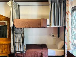 two bunk beds in a room with a bed at Rock View Hostel Ella in Ella