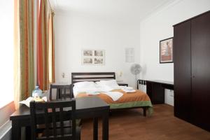 Ένα ή περισσότερα κρεβάτια σε δωμάτιο στο La Scala Apartments