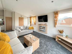 a living room with a couch and a fireplace at Holidays with TLC at Barlings Country Park in Lincoln