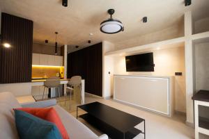 a living room with a couch and a table at Apartamentos Playazul in Playa de las Americas