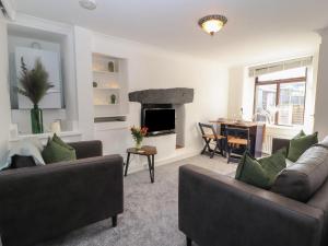 a living room with two couches and a dining room at Quarter Deck in Ulverston