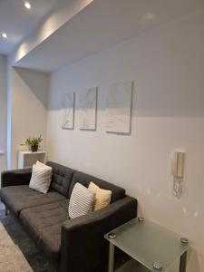 a living room with a couch and a table at Modern Apartment in City Centre in Manchester