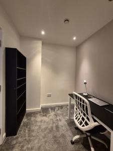an office with a desk and a chair and a cabinet at Modern Apartment in City Centre in Manchester