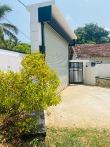 a garage next to a house with a gate at 682 Villa Weligama in Weligama +26 photos