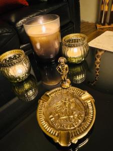 a gold pocket watch and candles on a table at 120m² Atomium,Brussels Expo,StadeRoiBaudoin,Cinéma in Brussels