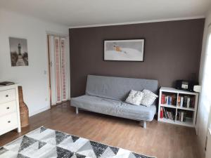 ein Wohnzimmer mit einer Couch und einem Bücherregal in der Unterkunft Ferienhaus Landliebe, Wohnung 9048-2 in Dänschendorf
