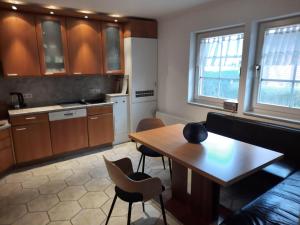 a living room with a table and a kitchen at Ferienhaus-Landliebe-Wohnung-9048-2 in Dänschendorf