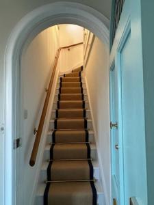 a staircase in a house with a stair case at Beautiful One Bed Apartment in West End Folkestone in Kent