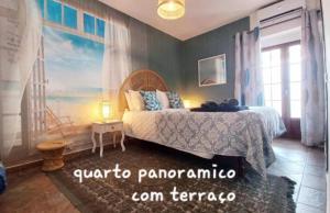 a bedroom with a bed with a painting on the wall at Casa Dona Antonia - Monsaraz in Monsaraz