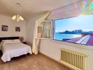 1 dormitorio con cama y ventana grande en Apartamento Paseo Marítimo-A Illa de Arousa, en A Illa de Arousa