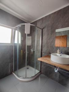 a bathroom with a glass shower and a sink at Vintage Place - Azorean Guest House in Ponta Delgada +57 photos