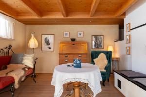 a living room with a table with a sign on it at Ferienhaus Casa Chapf in Amden