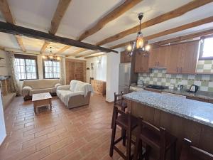 a kitchen and living room with a couch and a table at LA CUADRA in Gaucín