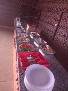 a buffet line with plates and bowls of food at Desert Nights Camp in Wadi Rum