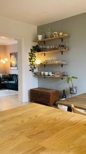 a living room with a wooden table and shelves at ApartmentInCopenhagen Apartment 1593 in Copenhagen