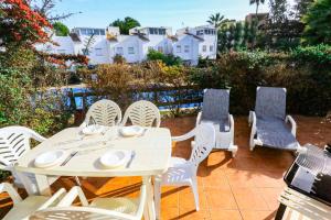 a white table and chairs on a patio at Casa de vacaciones LAS CUMBRES - ONLY FAMILIES in Salou