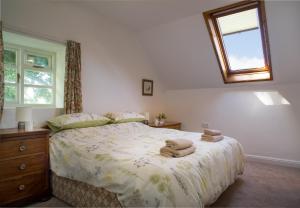 a bedroom with a bed with towels on it at Garden Cottage Newcastle Emlyn in Newcastle Emlyn